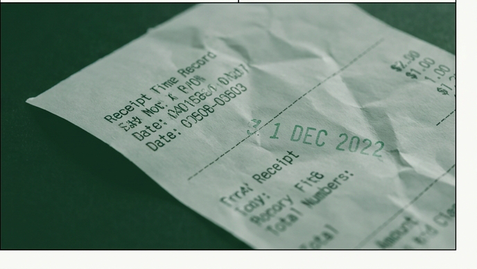 Macro shot of a paper receipt printed in green ink